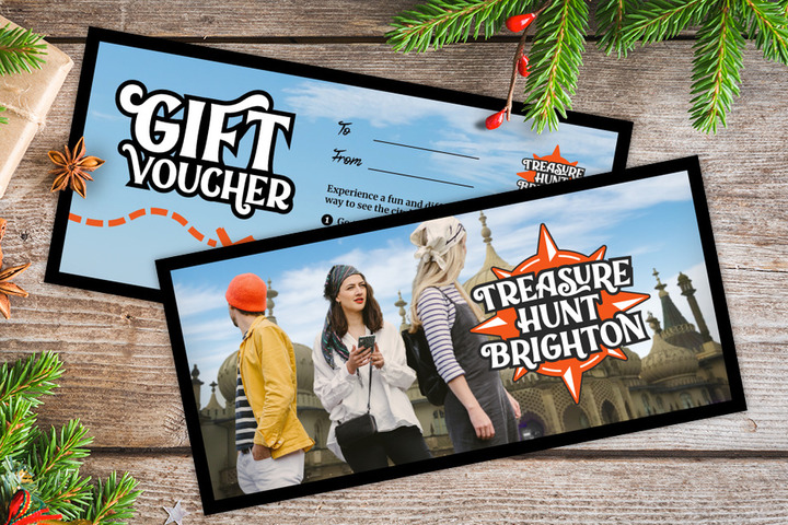 A gift voucher for Treasure Hunt Brighton on a table covered with Christmas decorations