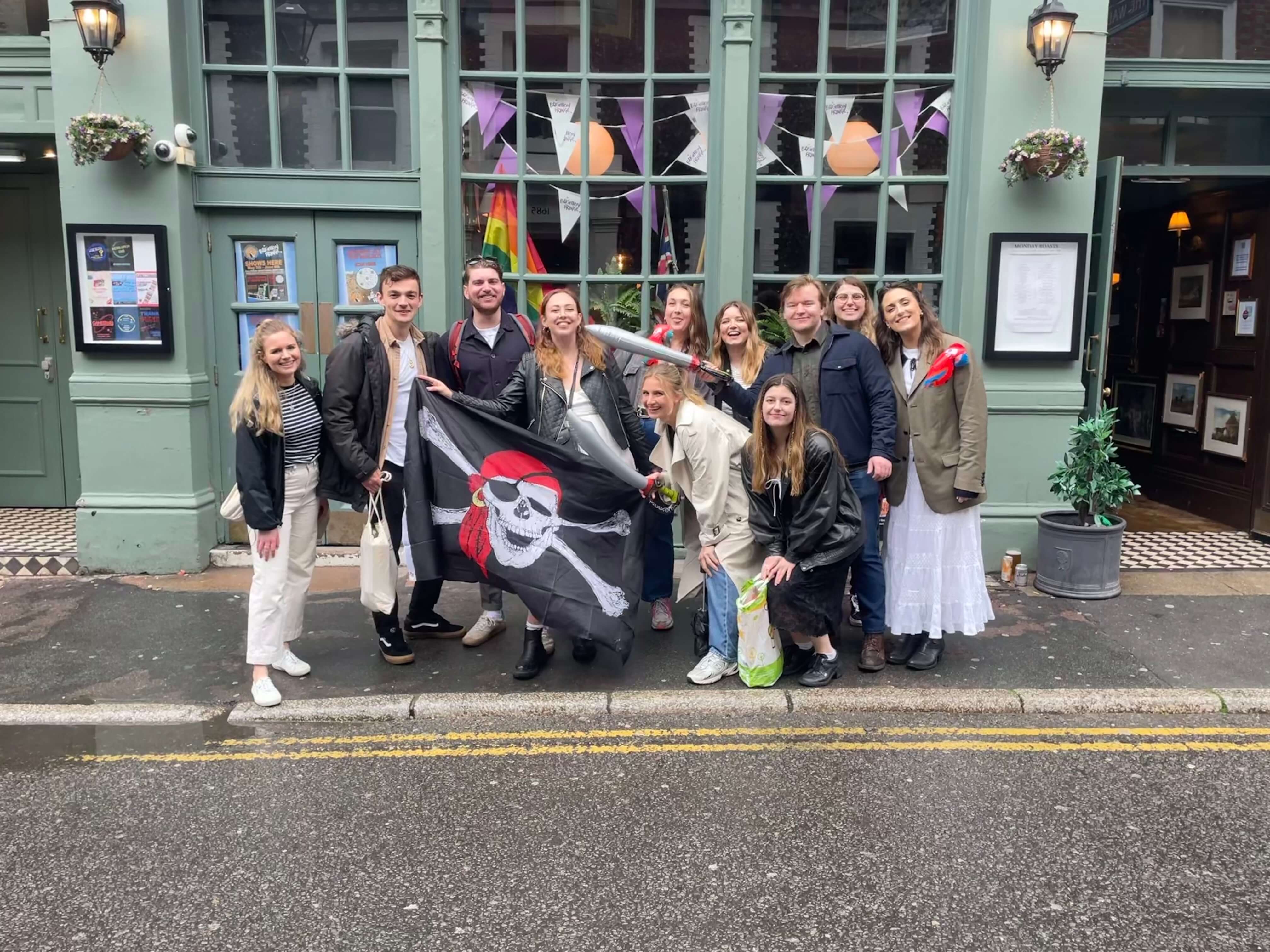 Graduates enjoying a drink together while playing Treasure Hunt Brighton